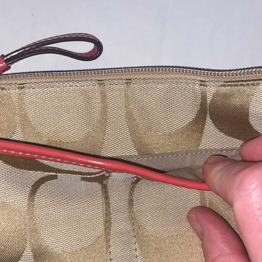 Tan and burnt orange Coach crossbody bag.